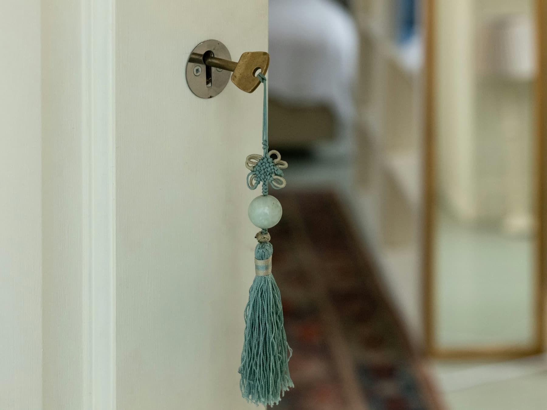 A key hanging from a condo door, representing guest handover support.