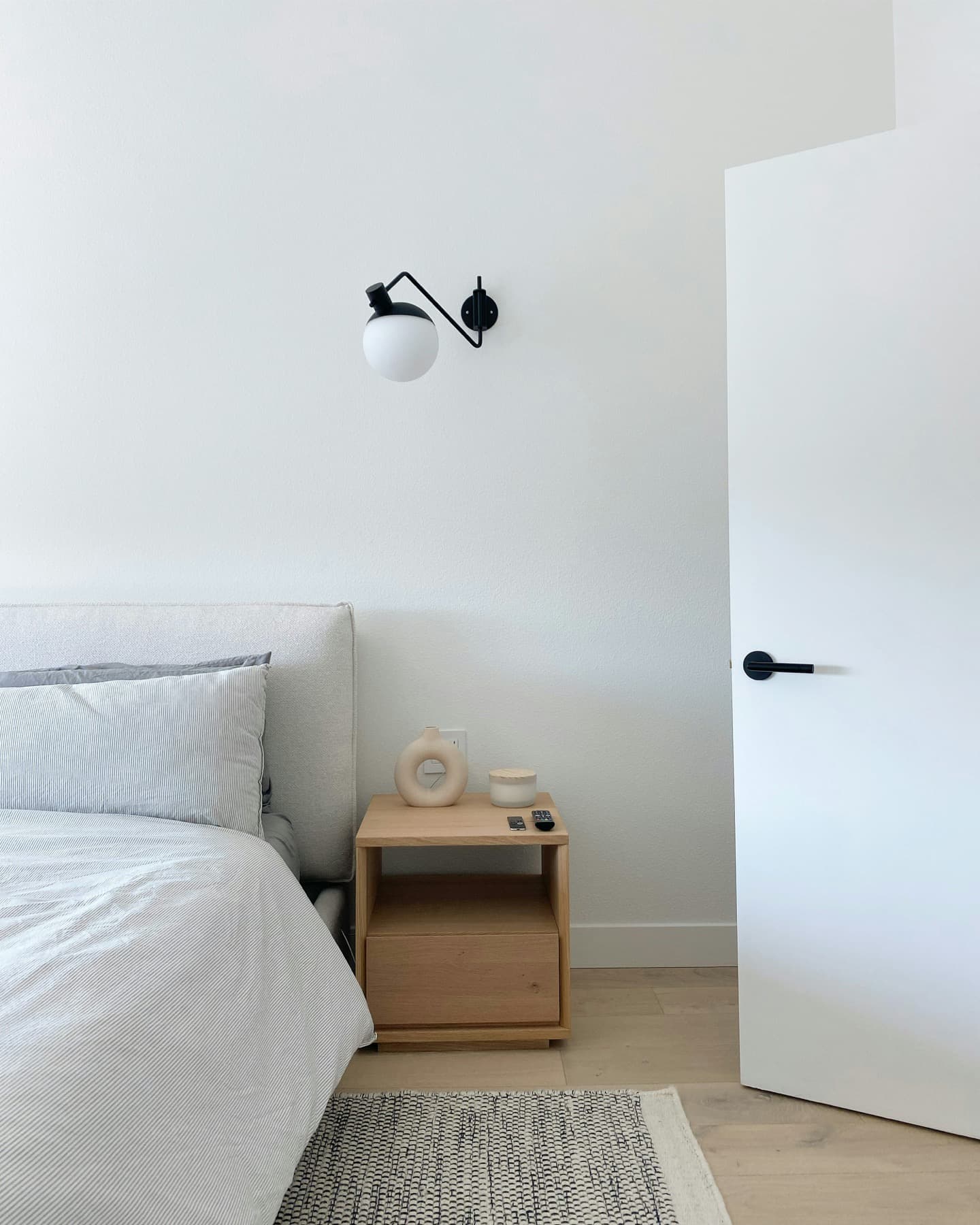 Folded white towels arranged on a bed to suggest linen and laundry service.